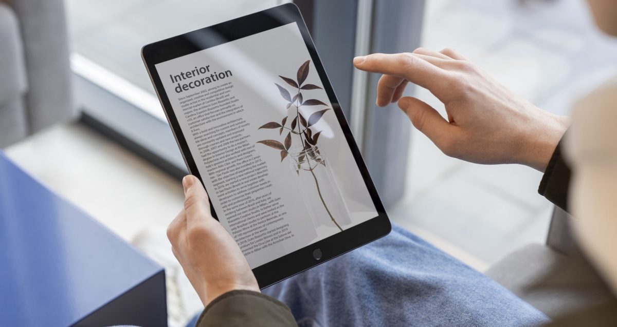 person-reading-online-magazine-using-digital-device